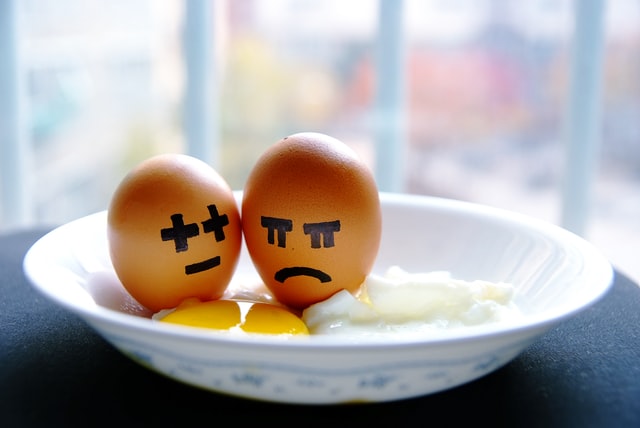 Eggs with drawn emotions, angry, sad