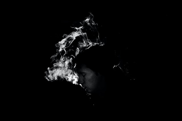 Cigarette smoke in black background